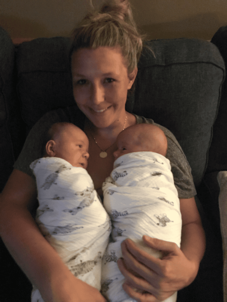 ann with twins in swaddle